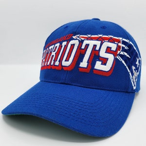 May include: A blue baseball cap with a white and red embroidered New England Patriots logo. The logo features a football helmet and the team name.