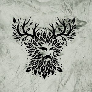 May include: A green t-shirt with a black and white graphic of a green man's face with antlers and leaves. The graphic is centered on the shirt.