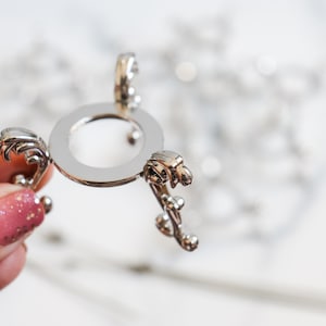 Ornate Metal Sphere Stands in Silver