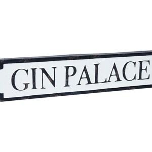 May include: Black and white sign with the text "GIN PALACE" in a vintage style.