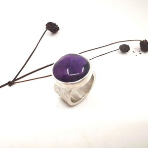 Amethyst in silver setting on a wide silver ring with texture, unique