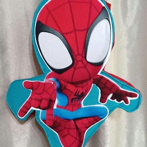 May include: A Spider-Man piñata in a cartoon style. The piñata is red and blue with a white outline and large white eyes. The Spider-Man piñata has outstretched hands and a black spider emblem on the chest.
