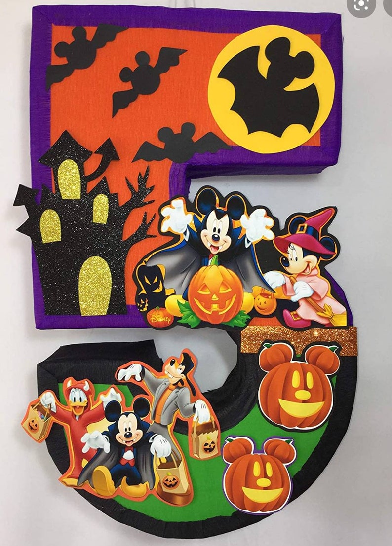 May include: A Halloween-themed number five pi&ntilde;ata featuring Mickey Mouse and friends dressed in costumes. The pi&ntilde;ata is decorated with bats, a haunted house, and pumpkins. The text "Disney" is visible on the pi&ntilde;ata.