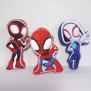 May include: Three cartoon Spider-Man figures, one in red and blue, one in black and red, and one in white, blue, and pink.