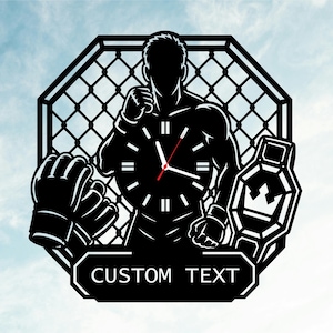 May include: A black wall clock featuring a silhouette of a mixed martial arts fighter inside an octagonal cage. The design includes a pair of fighting gloves, a championship belt, and a rectangular banner at the bottom with the text CUSTOM TEXT.