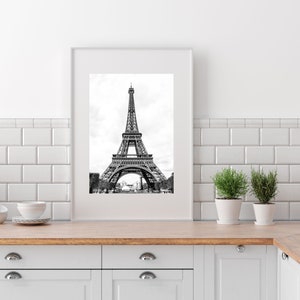 May include: A black and white photograph of the Eiffel Tower in Paris, France. The tower is a popular tourist destination and a symbol of the city.