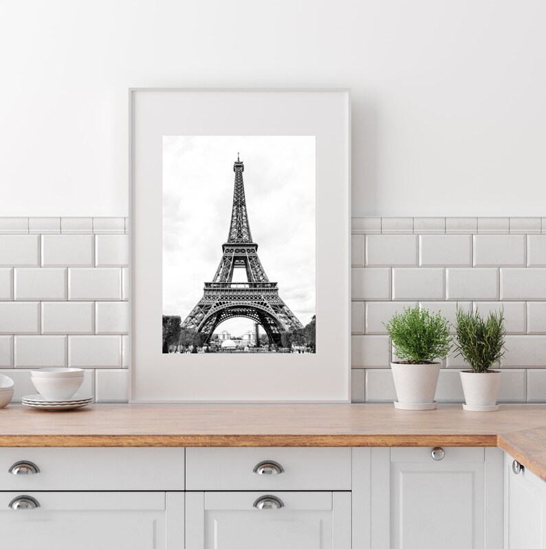 May include: A black and white photograph of the Eiffel Tower in Paris, France. The tower is a popular tourist destination and a symbol of the city.