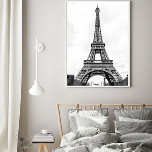 May include: A black and white photograph of the Eiffel Tower in Paris, France. The tower is a popular tourist destination and a symbol of the city.