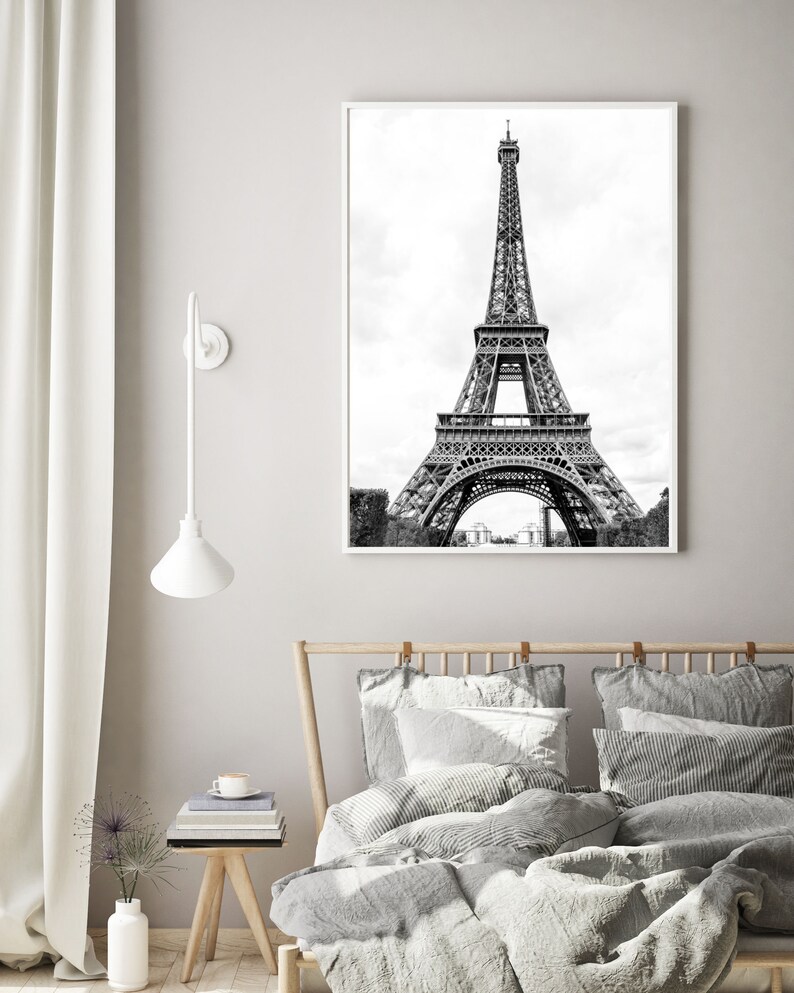 May include: A black and white photograph of the Eiffel Tower in Paris, France. The tower is a popular tourist destination and a symbol of the city.