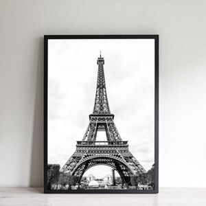 May include: A black and white photograph of the Eiffel Tower in Paris, France. The tower is a popular tourist destination and a symbol of the city.