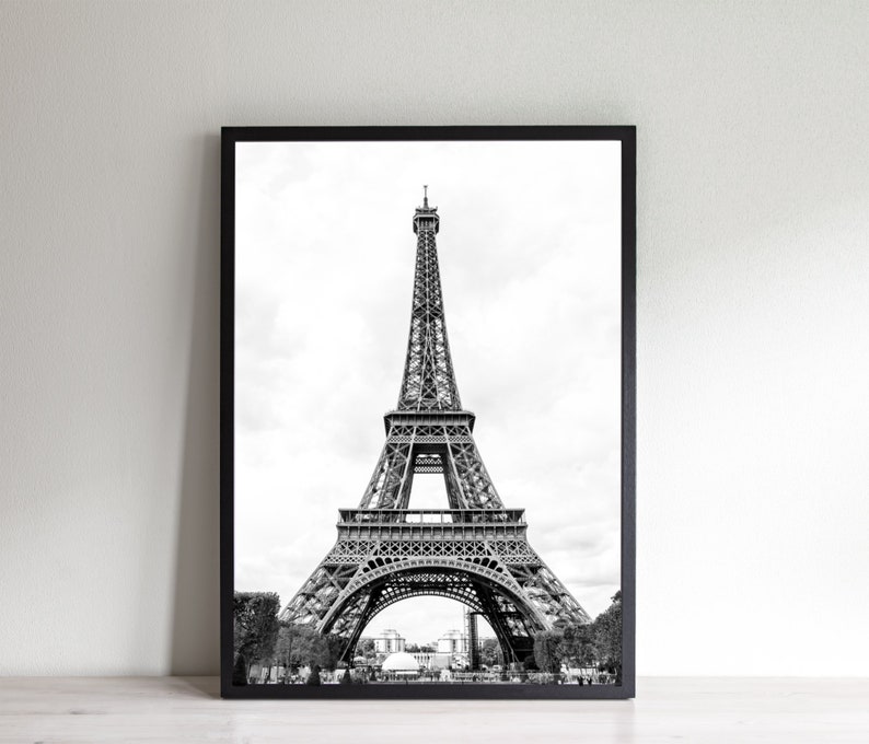 May include: A black and white photograph of the Eiffel Tower in Paris, France. The tower is a popular tourist destination and a symbol of the city.