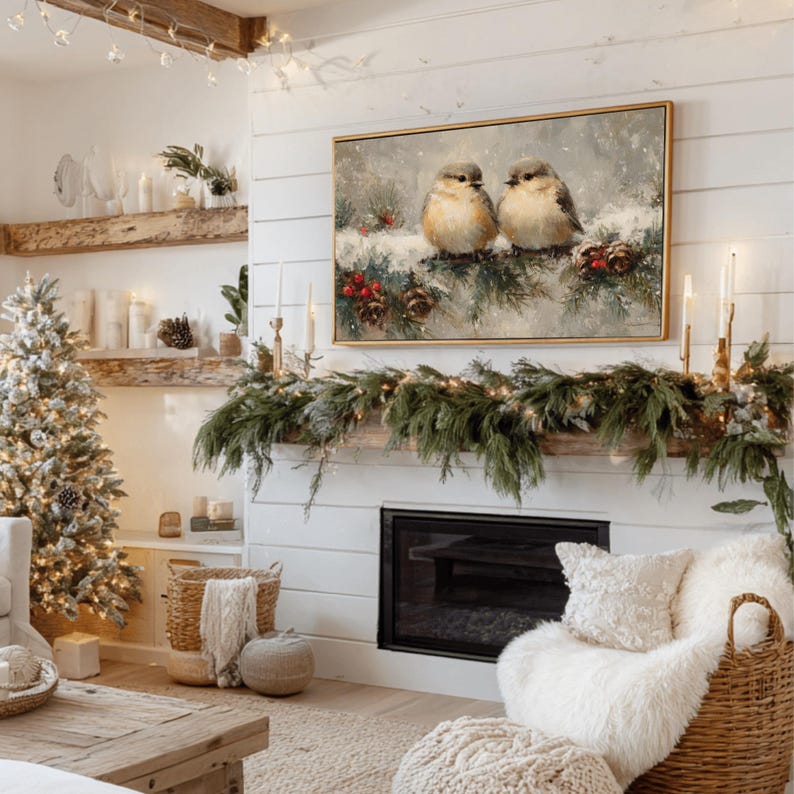 May include: A cozy living room scene with a Christmas tree, fireplace, and artwork. The artwork features two birds perched on a snow-covered branch. The fireplace is decorated with greenery and candles, creating a warm and inviting atmosphere.