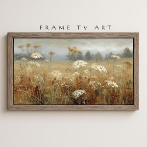 Puede incluir: Pintura de paisaje enmarcada que representa un campo de flores silvestres en tonos blancos, marrones y dorados. La obra de arte se encuentra sobre un fondo suave y apagado. El texto "FRAME TV ART" es visible en la parte superior.