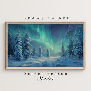 May include: A framed digital art print depicting a winter landscape with snow-covered evergreen trees under a vibrant aurora borealis. The artwork features a color palette of blues, greens, and purples. Text at the top reads "FRAME TV ART" and at the bottom "Screen Season Studio".