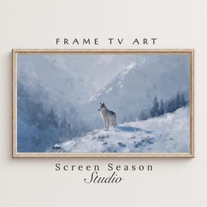 Könnte beinhalten: Gerahmter Kunstdruck mit einem Wolf auf einem schneebedeckten Hügel vor einer Bergkette. Das Kunstwerk ist in Blau- und Weißtönen gehalten, mit dem Text "FRAME TV ART" oben und "Screen Season Studio" unten.