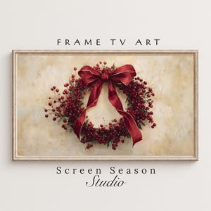 May include: A framed digital artwork depicting a festive Christmas wreath with red berries and a large red bow with gold edging. The background is a textured, off-white colour. The text at the top says "FRAME TV ART" and at the bottom "Screen Season Studio".