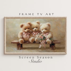 Könnte beinhalten: Gerahmter digitaler Kunstdruck mit drei Teddybären auf einer Holzbank. Die Bären sind hellbraun mit rosa Schleifen und einem Blumenstrauß. Der Text "FRAME TV ART" und "Screen Season Studio" befindet sich oben und unten am Rahmen.