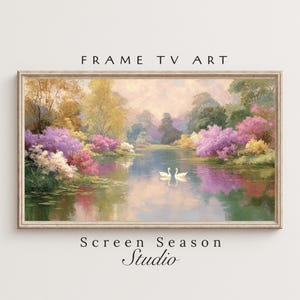 Könnte beinhalten: Ein gerahmtes Landschaftsgemälde mit einer ruhigen Seeszene mit zwei weißen Schwänen. Das Kunstwerk zeigt lebendige rosa, lila und gelbe blühende Bäume am Ufer. Der Text "FRAME TV ART" und "Screen Season Studio" sind sichtbar.