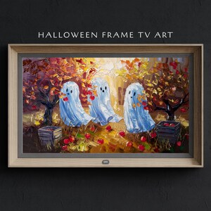 Könnte beinhalten: Gerahmte TV-Kunst zum Thema Halloween. Das Kunstwerk zeigt drei freundliche Geister in hellblauen Tüchern, die in einer farbenfrohen Herbstszene mit roten Äpfeln und Bäumen stehen. Der Rahmen ist aus hellem Holz, mit dem Text "HALLOWEEN FRAME TV ART".
