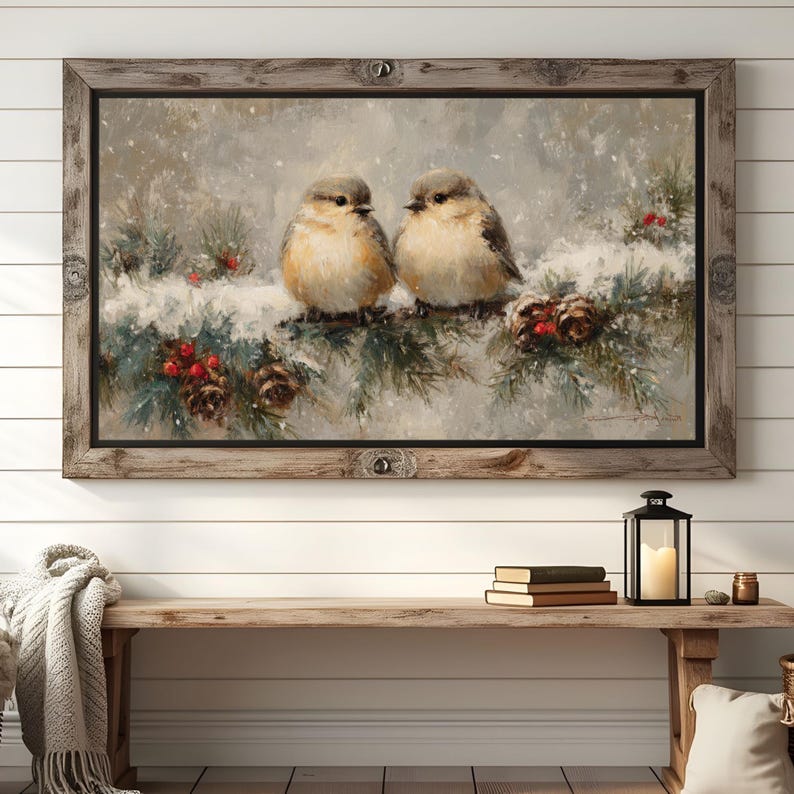 May include: A framed painting depicts two small birds perched on a snow-covered branch with pine needles, red berries, and pine cones. The artwork has a rustic, wintery theme, with a wooden frame.