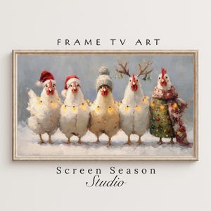 May include: A framed digital art print featuring five chickens in winter attire. The chickens are wearing Santa hats, a knit cap, a scarf, and antlers. They are adorned with string lights, standing in the snow. The text "FRAME TV ART" and "Screen Season Studio" are visible.
