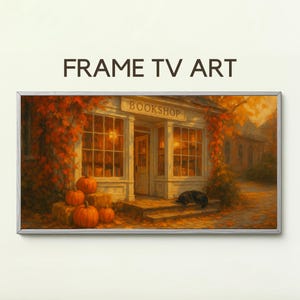 Könnte beinhalten: Ein gerahmter digitaler Kunstdruck mit dem Text "FRAME TV ART". Das Kunstwerk zeigt eine gemütliche Buchhandlungsszene mit Kürbissen, Herbstlaub und einem schwarzen Hund. Das Wort "BOOKSHOP" ist über dem Eingang zu sehen.