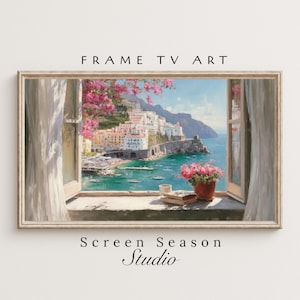 Könnte beinhalten: Gerahmter digitaler Kunstdruck, der eine italienische Küstenstadt durch ein offenes Fenster zeigt. Das Kunstwerk zeigt ein lebendiges blaues Meer, weiße Gebäude und rosa Blumen. Der Text "FRAME TV ART" und "Screen Season Studio" sind sichtbar.