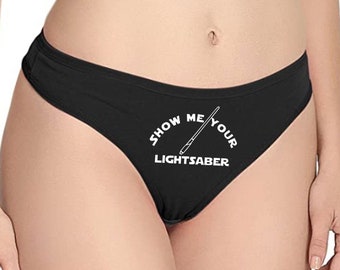 May include: Black lace underwear with the text "Show Me Your Lightsaber" and a graphic of a lightsaber.