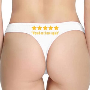 May include: White thong underwear with five yellow stars and the text "Would eat here again".