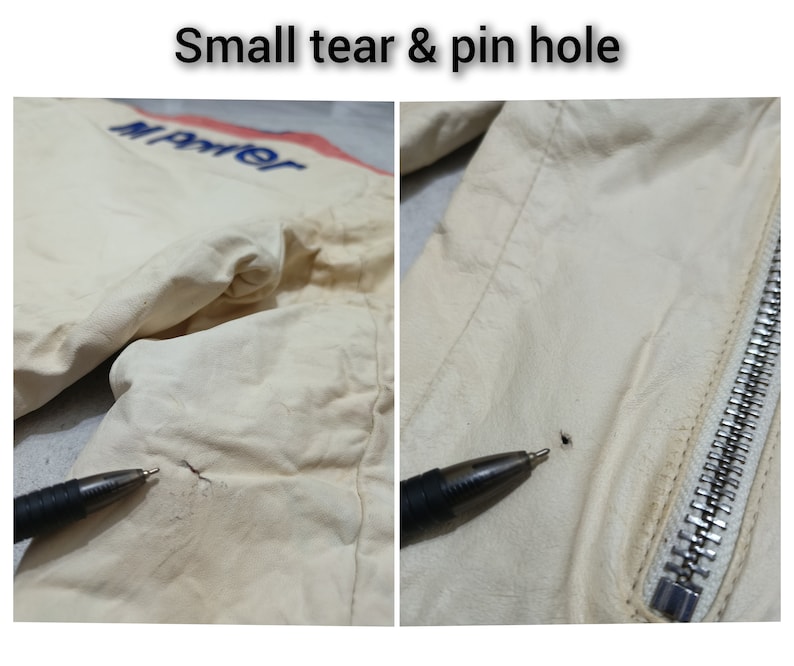 May include: Close-up of a white leather jacket with a small tear and a pinhole. The jacket has a zip on the right side and the word "Marter" is embroidered on the left side.