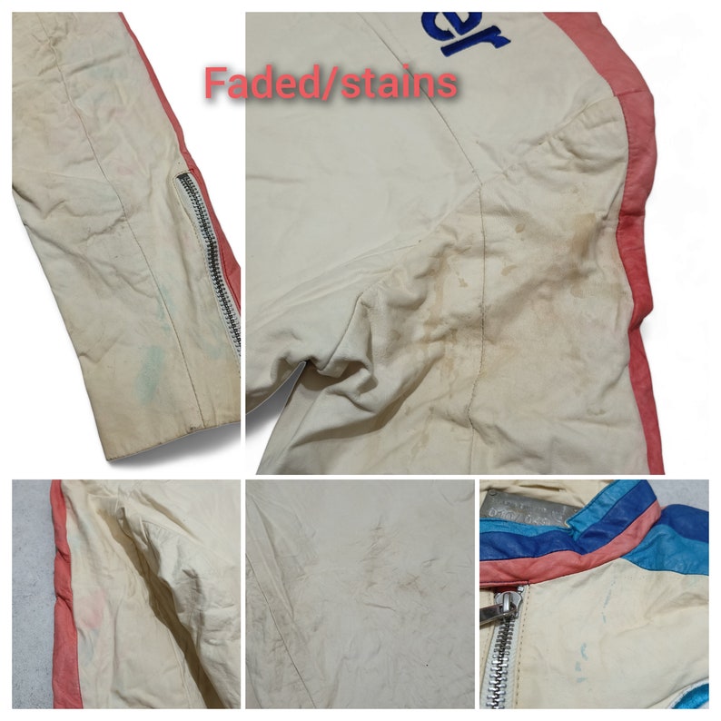 May include: A white leather jacket with faded and stained areas. The jacket has a red and blue stripe down the side and a zipper closure. The text "Faded/stains" is written in red on the jacket.