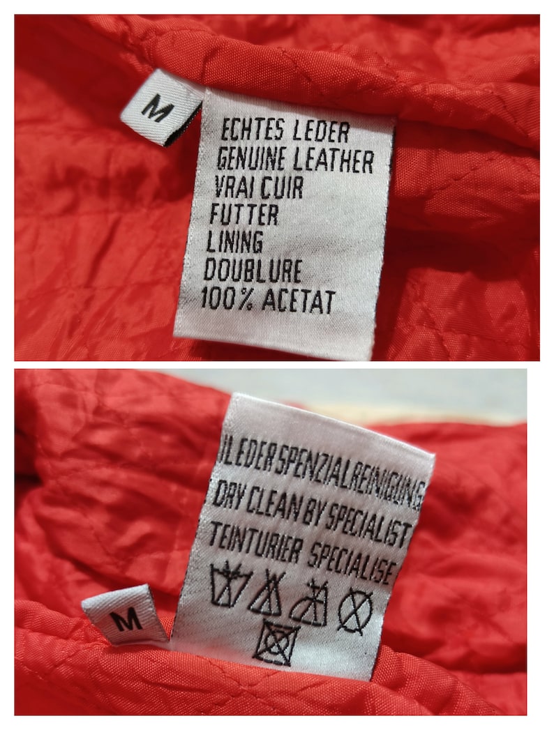 May include: White label with black text on a red fabric background. The label reads "Echtes Leder Genuine Leather Vrai Cuir Futter Lining Doublure 100% Acetat". A second white label with black text reads "I Leder Spezialreinigung Dry Clean by Specialist Teinturier Specialise". The label has a symbol for dry clean only, do not bleach, do not tumble dry, iron at low temperature, and do not dry clean.