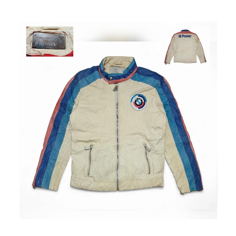 May include: A cream-coloured jacket with blue, pink and white stripes on the sleeves. The jacket has a zip closure and a BMW logo on the front. The jacket also has a label that says "010/049" on the inside.