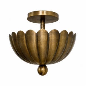 May include: A brass-colored ceiling light fixture with a scalloped bowl-shaped shade. The fixture has a round base and a decorative stem. A small, round ball hangs from the bottom of the shade. The light is designed to be mounted on a ceiling.
