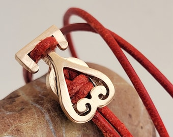 red leather strap with bronze heart closure