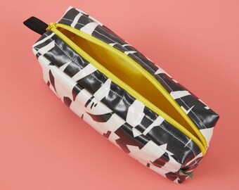 Black and white boxy wash bag with contrasting yellow waterproof lining and YKK zip, Laminated black and white wash bag with lining