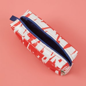 Red and white boxy wash bag with contrasting navy blue waterproof lining and YKK zip, Laminated red and white wash bag with lining image 1