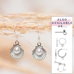May include: Silver earrings with a pearl in a seashell design. Also available as hoop earrings, clip-on earrings, and a single earring.