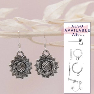 May include: Silver sunflower earrings with a delicate design. Also available as a stud, hoop, or clip-on earring.