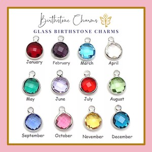 May include: A collection of twelve glass birthstone charms in various colors, each with a silver-tone loop. The charms are arranged in a grid and labeled with the months of the year. The text "Birthstone Charms" and "Glass Birthstone Charms" are displayed at the top.
