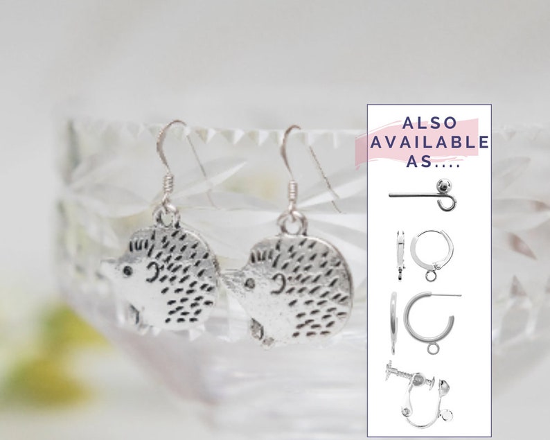 May include: Silver hedgehog earrings with a textured finish. The earrings are shown on a clear glass surface. ALSO AVAILABLE AS... is written in pink text on a white background. The text is followed by four different earring styles.