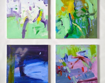 May include: Four abstract paintings in a grid pattern. The top left painting is green with purple and yellow accents. The top right painting is green with yellow, blue, and orange accents. The bottom left painting is blue with purple and green accents. The bottom right painting is purple with green, blue, and red accents.