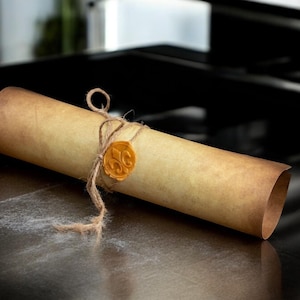 May include: A rolled parchment scroll, secured with twine and a gold wax seal. The scroll is a light brown hue, and the seal bears a decorative emblem. The background is dark and reflective, with a polished surface.
