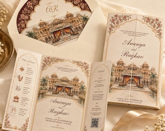 May include: A cream-colored wedding invitation set featuring an illustration of a palace with orange and red drapes. The text includes the names Ananya and Raghav, event details, and a QR code. The design is framed by floral borders in shades of pink and green.