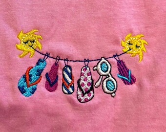 Camiseta rosa de algodón con bordado ZEN en la playa