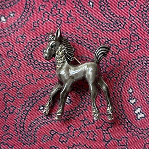Vintage silver tone, enamel and diamanté horse brooch.