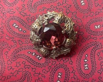Vintage silver tone and purple glass Scottish Celtic thistle brooch by Miracle.