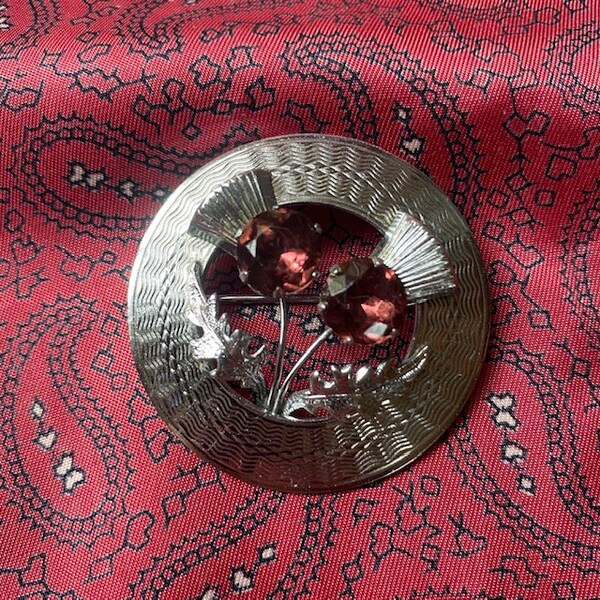 Vintage silver tone and sparkling diamanté Celtic thistle brooch.