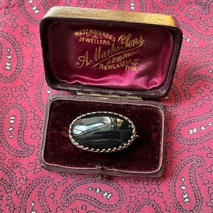 Exquisite vintage 1970s silver brooch set with a banded black jasper cabochon.