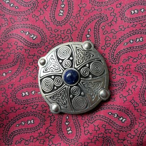 Vintage pewter and blue stone circular Celtic geometric design brooch by St. Justin.